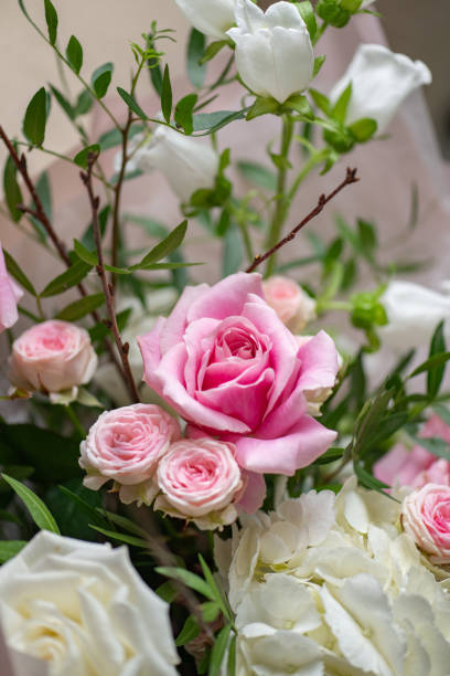 istock Delicate composition of white and pink flowers in vertical format. Close up 2203383389