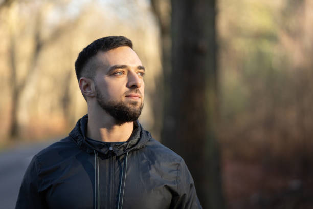 istock A young man looking at the nature around him and smiling 2203384417
