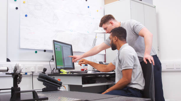 istock Two Male Engineers Uses CMM Coordinate Measuring Machine In Factory 2203384480