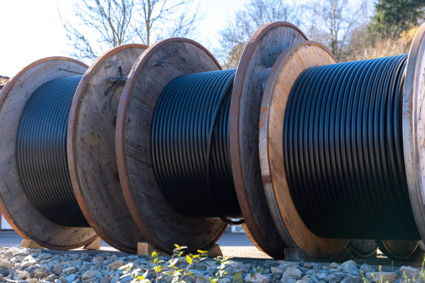 istock Large industrial reels with electrical cables are located at a construction site. They provide ease of installation and are used in energy and communication industries. 2203384699