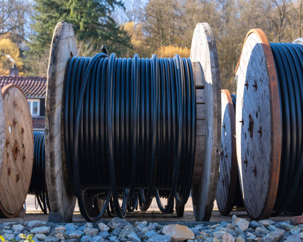 istock Large industrial reels with electrical cables are located at a construction site. They provide ease of installation and are used in energy and communication industries. 2203384937