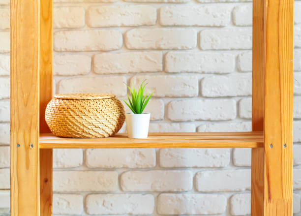 istock Wooden rack shelf with home decor stuff 2203387434