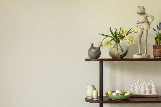 istock Minimalistic Easter shelf decor with ceramic bunny figurines, pastel eggs, and spring flowers in a neutral interior. Copy space. 2203388655