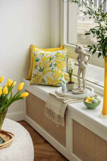 istock Spring home decor with ceramic frog sculptures, seasonal flowers, and pastel Easter decorations on a wooden shelf. 2203388781