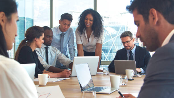 istock Business Team Around Table In Modern Office Collaborating Together 2203390609