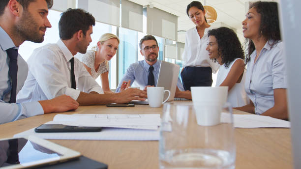 istock Business Team Around Table In Modern Office Collaborating Together 2203390628
