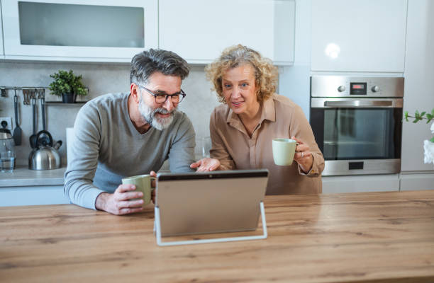 istock Mature couple using tablet to browse or read together 2203392393