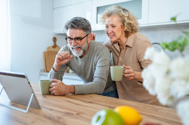 istock Mature couple using tablet to browse or read together 2203392426