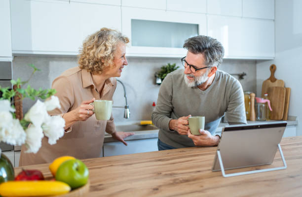 istock Mature couple using tablet together in the kitchen 2203392460