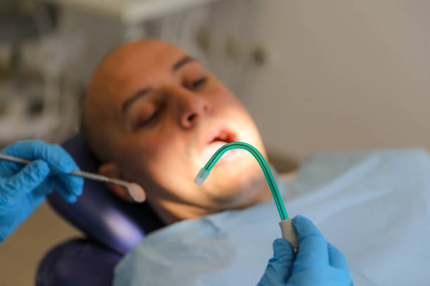 female dentist prepares for work, holding dental instruments in her hands.