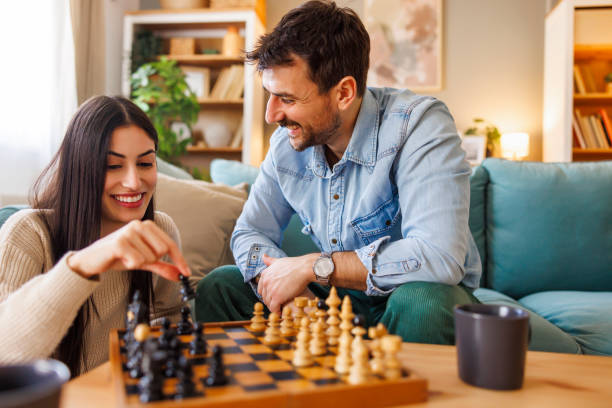 istock Couple playing chess while enjoying leisure time at home 2203394794