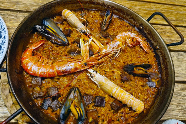 istock Delicious Seafood Paella with Shrimp, Mussels, and Squid in Rustic Pan 2203395990