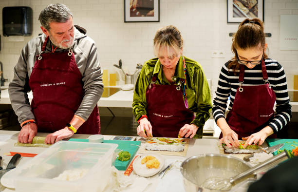 istock Participants Engaged in a Hands-On Sushi-Making Class 2203397429