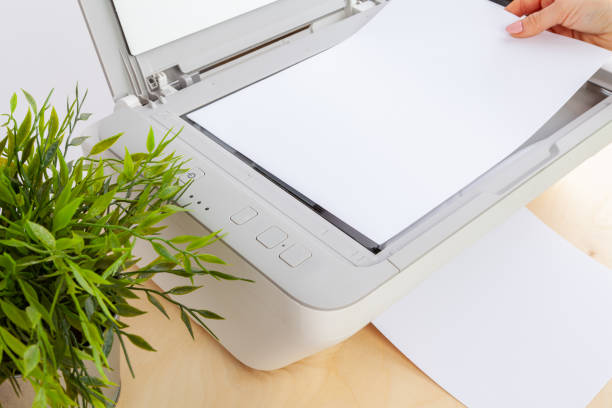 istock Hands of a woman using a copying machine close up 2203397792