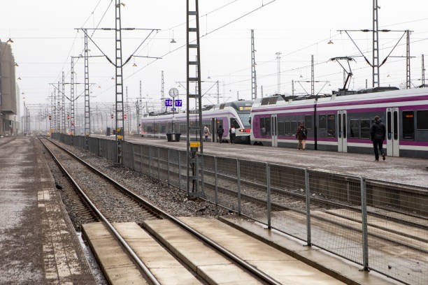 istock Passengers walking along a railway platform next to a modern train in winter 2203398717