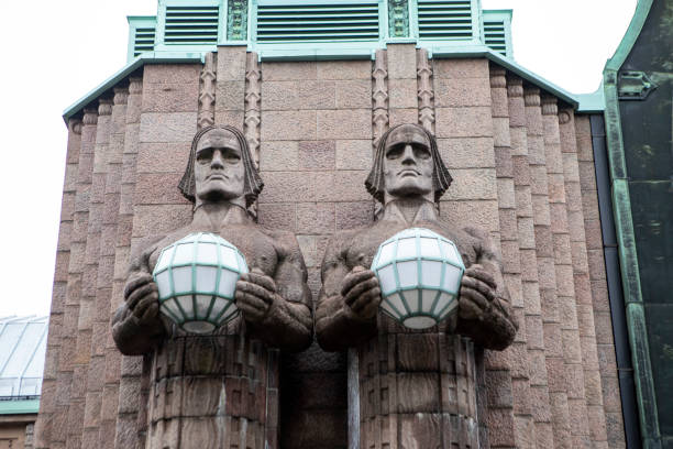 Helsinki Central Station is the main station for commuter rail and long-distance trains departing from Helsinki, Finland. The two stone statues are named Lyhdynkantajat (The Lantern Bearers).