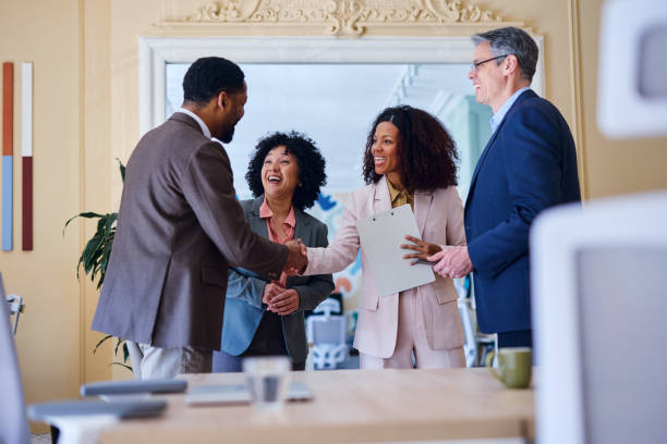 istock Business people shaking hands during a meeting in a modern office 2203400712