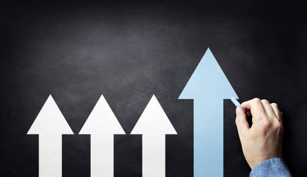 istock Business concept drawing growth arrows on blackboard 2203401431