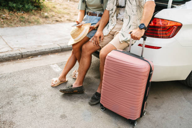 istock Tourists, white car and luggage 2203402603