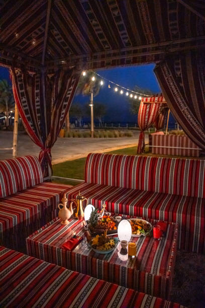 istock Traditional Arabic tent with seating sofa and festive Iftar table for ramadan fast breaking celebration in outdoor garden lawn on Abu Dhabi lawn 2203402742