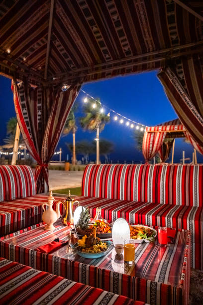 istock Traditional Arabic tent with seating sofa and festive Iftar table for ramadan fast breaking celebration in outdoor garden lawn on Abu Dhabi lawn 2203402743