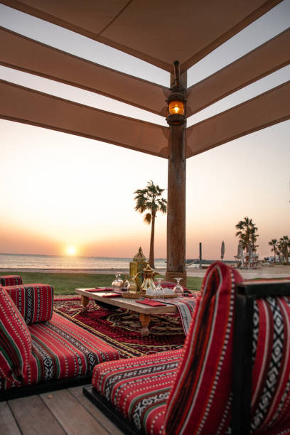 istock Traditional Arabic seating sofa and festive Iftar table with coffee and dates for ramadan fast breaking celebration in outdoor beach side in Abu Dhabi 2203402954