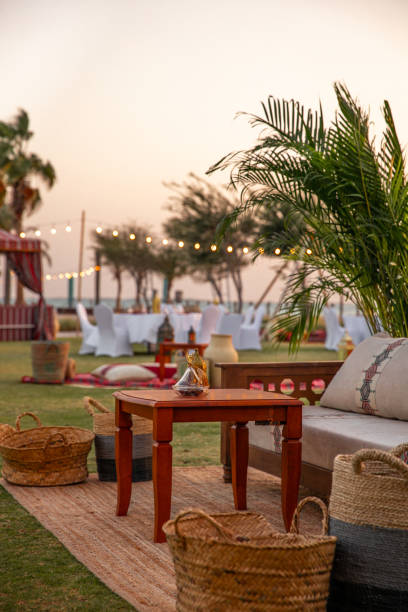 Traditional Arabic seating sofa and festive Iftar table with coffee and dates for ramadan fast breaking celebration in outdoor beach side in Abu Dhabi