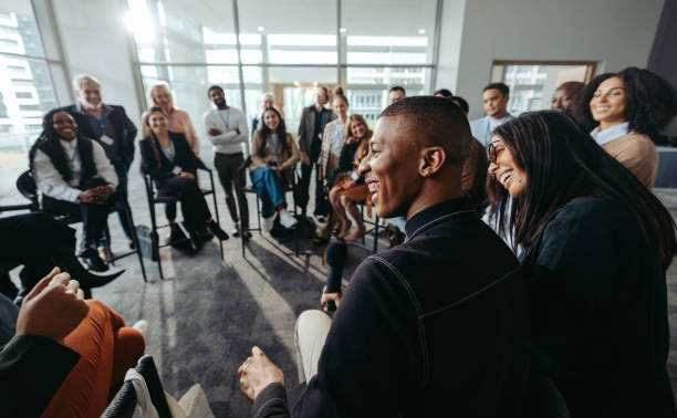 istock Group of happy and attentive people enjoying interactive conference session 2203403536