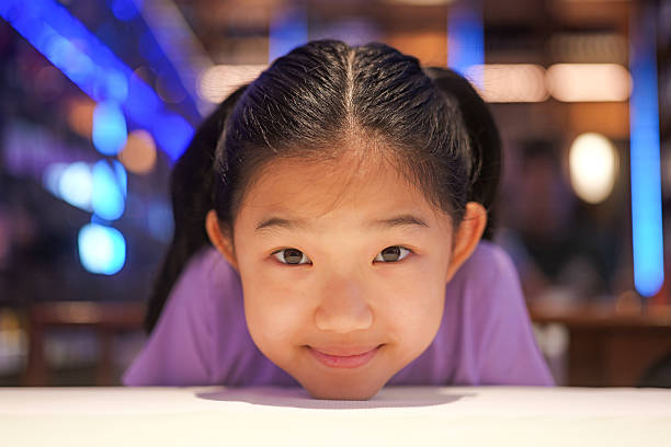 Image of a girl with mischievous eyes and messy hair.