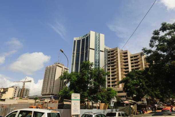 Abidjan, Ivory Coast - November 16, 2024: Modern skyscrapers rise against a bright sky in Abidjan, reflecting the urban growth in Ivory Coast.