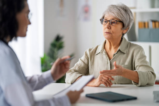 istock patient with a doctor in medical office 2203404146