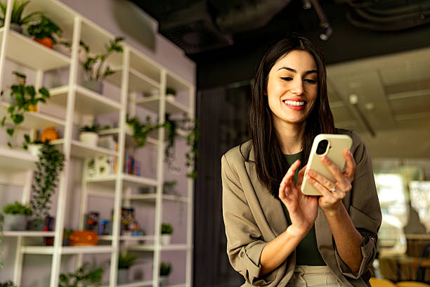 istock Businesswoman using phone in the office 2203407544