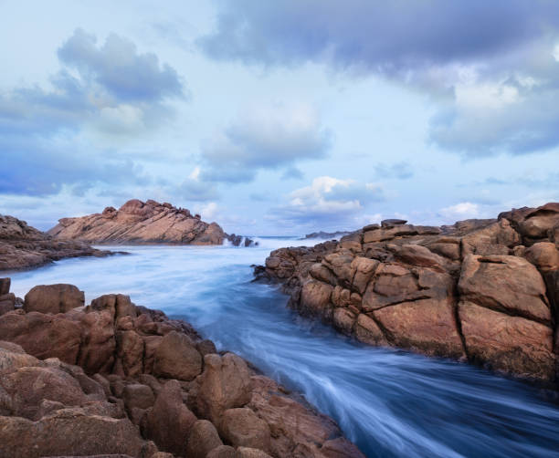 Water rushing through rock formations before sunrise