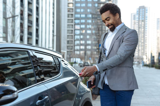 istock Professional man unlocking his modern car in an urban environment 2203409211