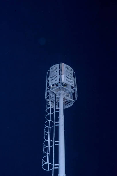 istock A dark night sky and a tall white communication tower. 2203409357