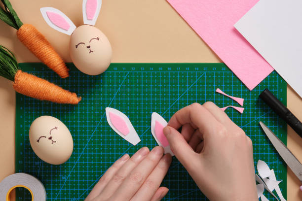 istock DIY Easter Bunny Egg Craft. Step-by-step instructions. Step 5. Glue the pink parts of the bunny ears to the light colored parts. 2203410315