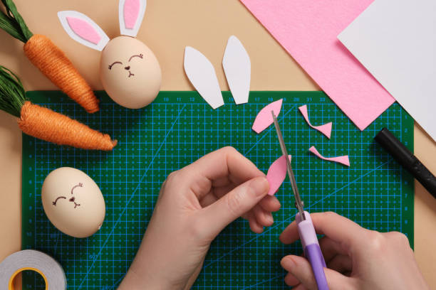 istock DIY Easter Bunny Egg Craft. Step-by-step instructions. Step 4. Cut out the inside of the bunny ears from pink fabric or paper 2203410316