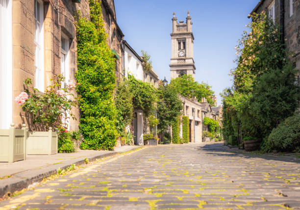 View along the narrow Bridewell Lane in the centre of the historic city of Bath, Somerset.  The road has now been converted to a pedestrian walkway and allows people to walk away from the cars.