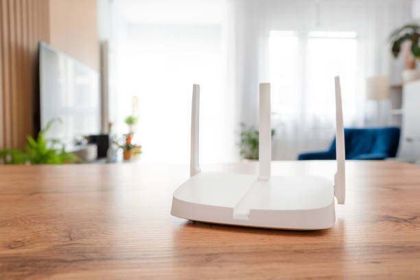 istock Modern wi-fi router on light table in room 2203415275