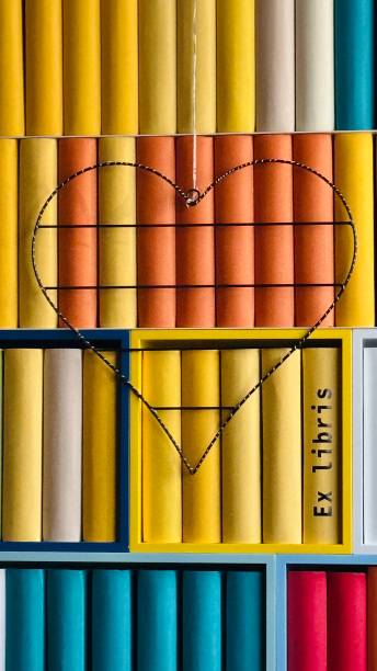 istock Library, colorful generic books spines with a heart shape hanging at it 2203415322