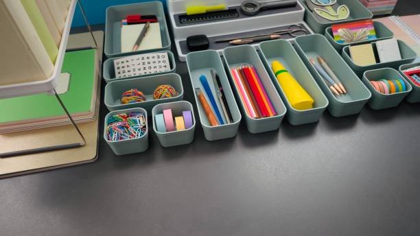 istock Desk organization, office supply boxes on a gray desk 2203416679