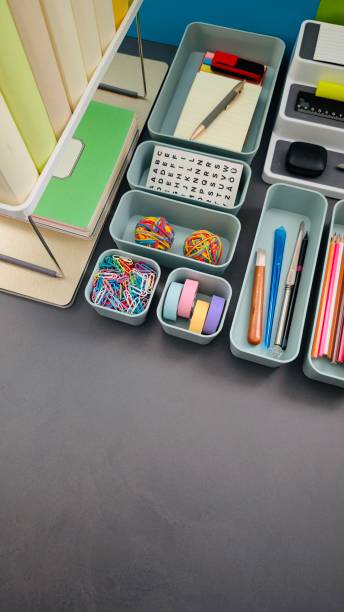 istock Desk organization, office supply boxes on a gray desk 2203416797
