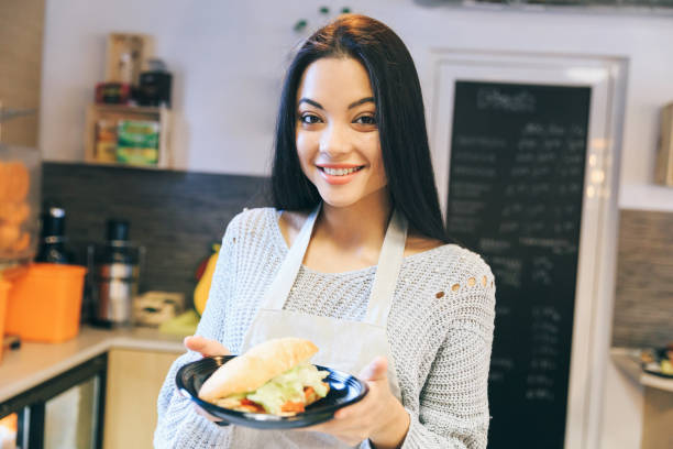 istock Female asian worker in fast food restaurant 2203416810