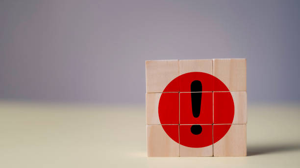istock Important Error Alert red Flag Exclamation Icon on wooden cube block stacking for Warnings and Communication Mistakes, danger signs, and critical attention notifications. 2203417828
