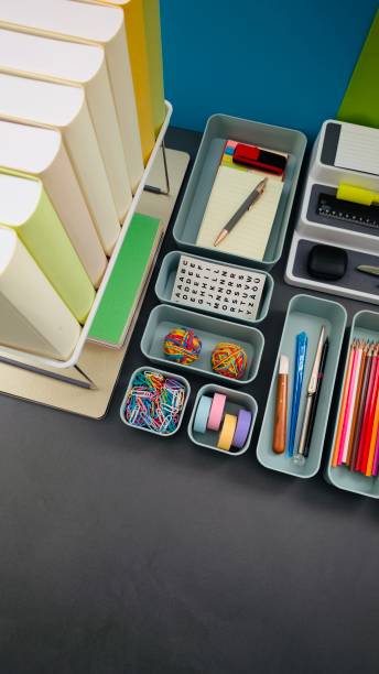istock Desk organization, office supply boxes from above on a gray desk 2203417849