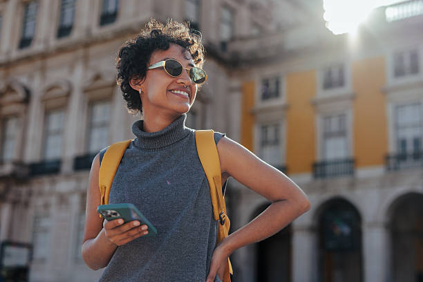 istock Tourist with backpack and smart phone exploring european city 2203417885