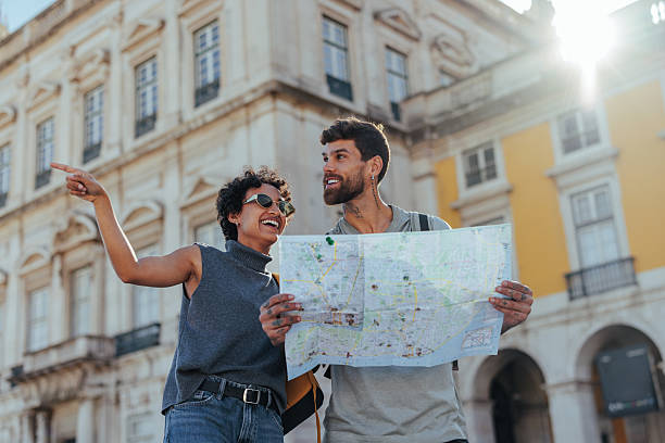 istock Happy tourists holding map and exploring city center 2203417902