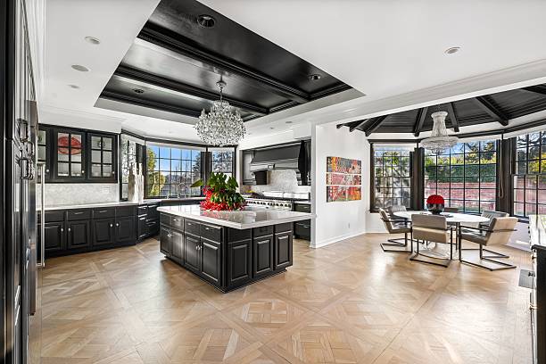 istock Elegant dining room and a kitchen with modern decor, large windows, crystal chandelier, glass table 2203418205