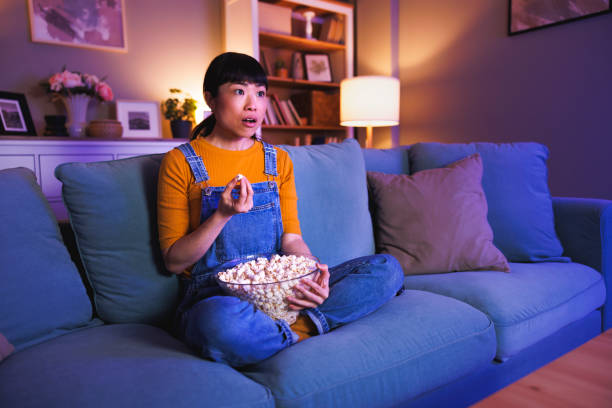 istock Woman shocked while watching TV late at night 2203418841