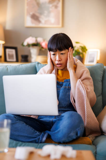 istock Woman having headache consulting with doctor using laptop computer 2203419056